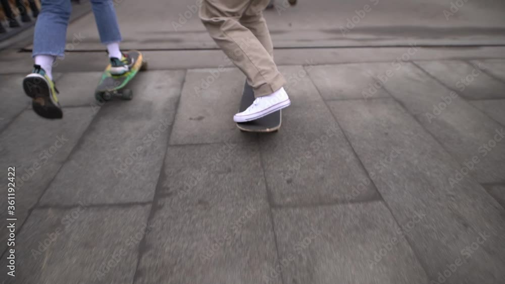 Group of young people skateboarding on the road in the early morning with red signal flare, slow motion Group of young people skateboarding on the road in the early morning with red signal flare, slow motion