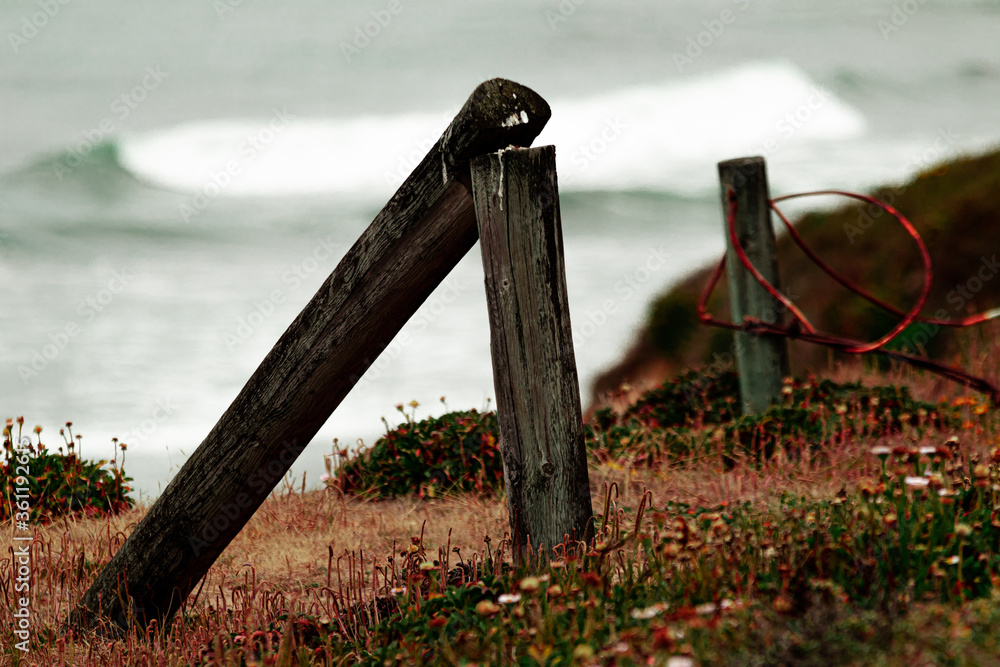 Fototapeta premium Old fence, broken fence, rusted fence on beach