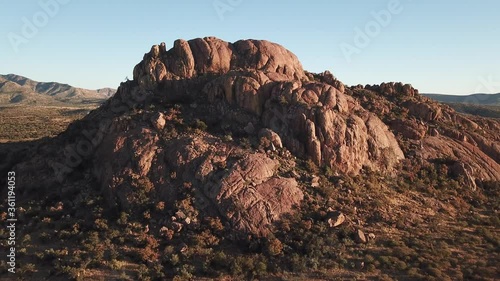 4K aerial drone video of African savanna hills, large red granite boulders range near B1 highway south of Windhoek in central highland Khomas Hochland of Namibia, southern Africa
