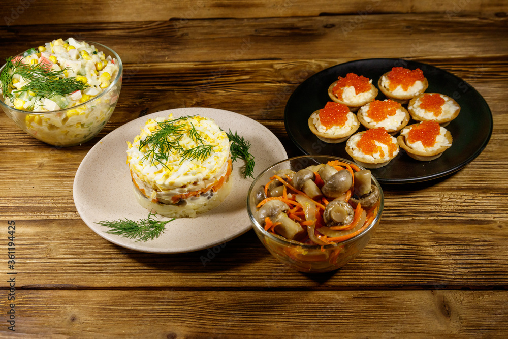 Set of various festive dishes on a wooden table Set of various festive dishes on a wooden table