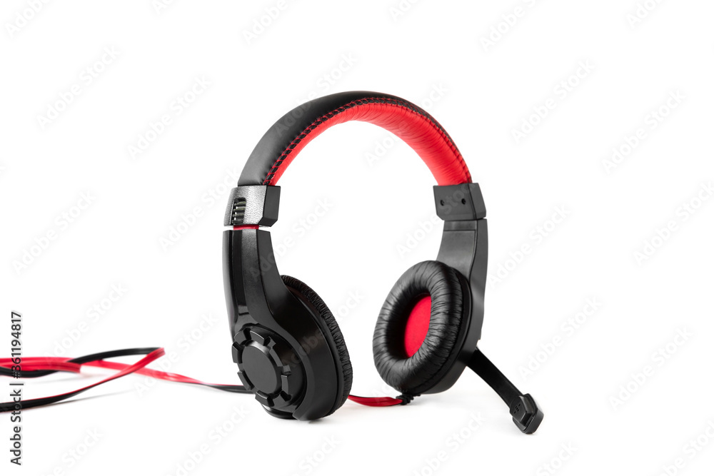Gaming headphones in black and red with a wire on a white isolated background. Gaming headphones in black and red with a wire on a white isolated background.