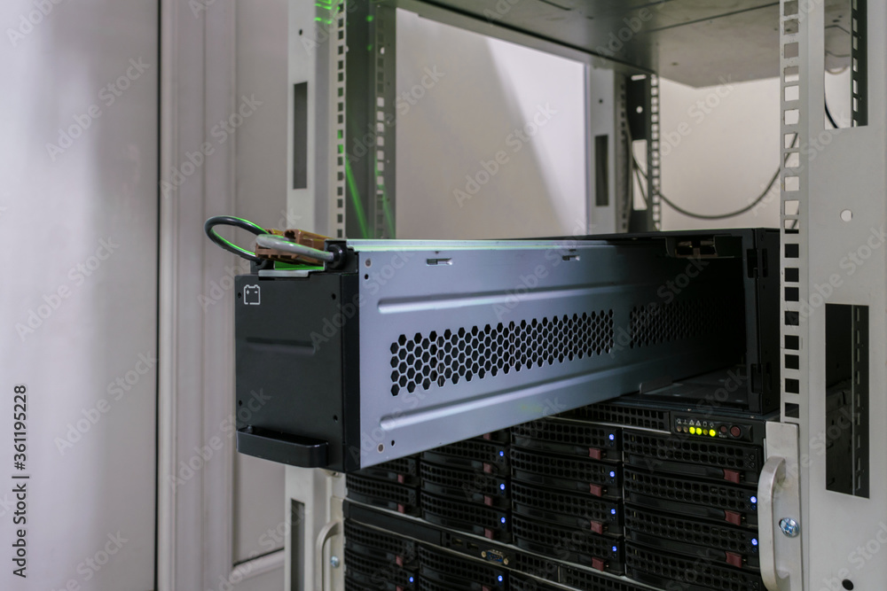 Large battery close-up. Changing the power module in the server room close-up. Working with equipment in the datacenter rack Large battery close-up. Changing the power module in the server room close-up. Working with equipment in the datacenter rack