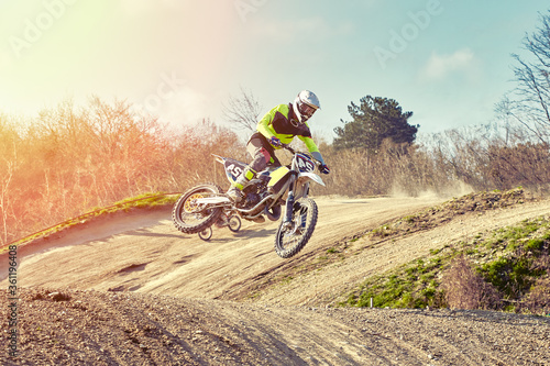 Fototapeta Naklejka Na Ścianę i Meble -  Motocross concept, a biker goes off-road making extreme skiing. In pursuit of adrinalin, sport concept. Dangerous sport.