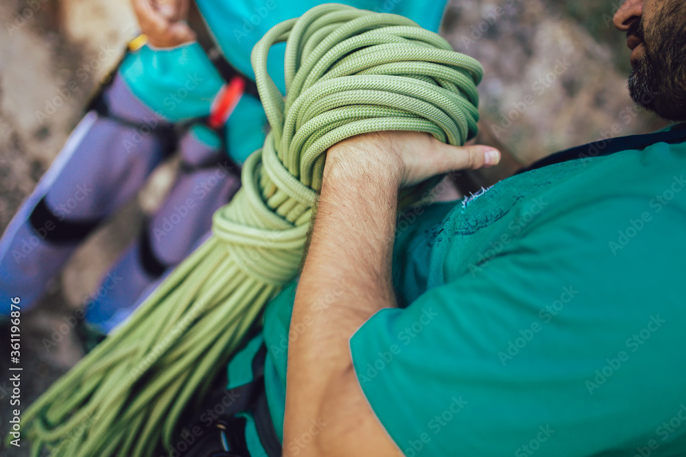Senior man with a rope preparing for climbing on the rock. Senior man with a rope preparing for climbing on the rock.