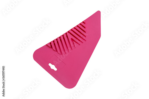 Pink plastic spatula for wallpapering isolated on white background