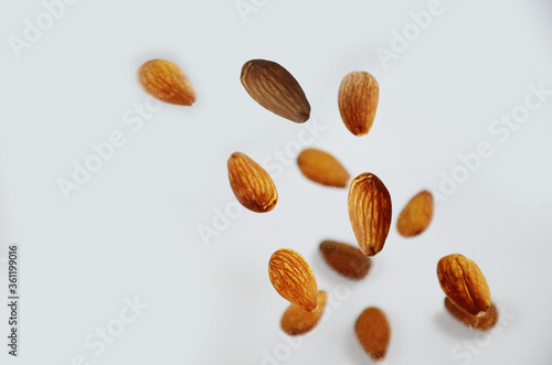 almonds fly on a white background. Composition of nuts flat lay almonds on white background. Concepts about decoration, healthy eating and food background.