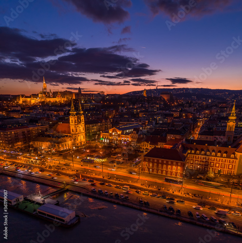 Aerial drone shot of Matthias Churh, St. Anne Church and market hall by Danube in Budapest sunset