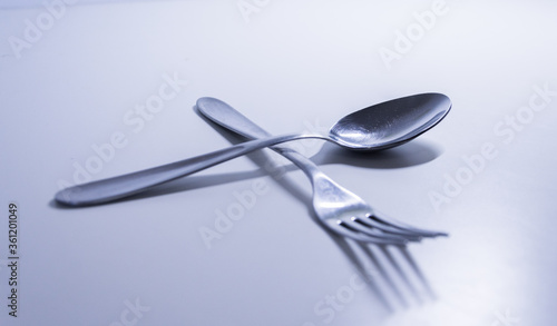 Fork and a spoon in a white background. Cookware and tableware for menus and restaurants.  photo