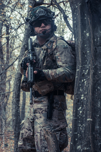 portrait of a soldier with a gun in the forest of Battlefield/army uniform with a weapon.