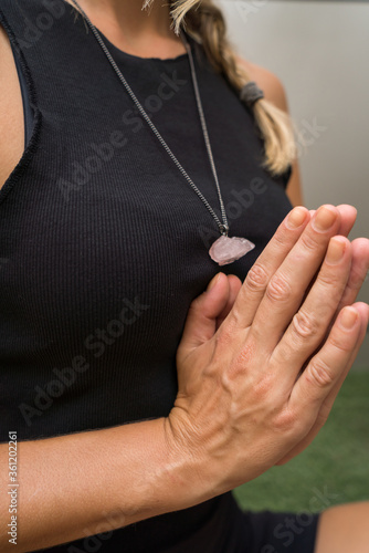 Woman meditating wearing crystal spiritual necklace © sashapritchard