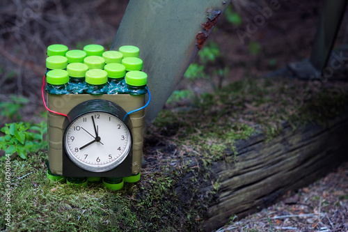 Slika na platnu Improvised time bomb planted near metal device on old wood with green moss