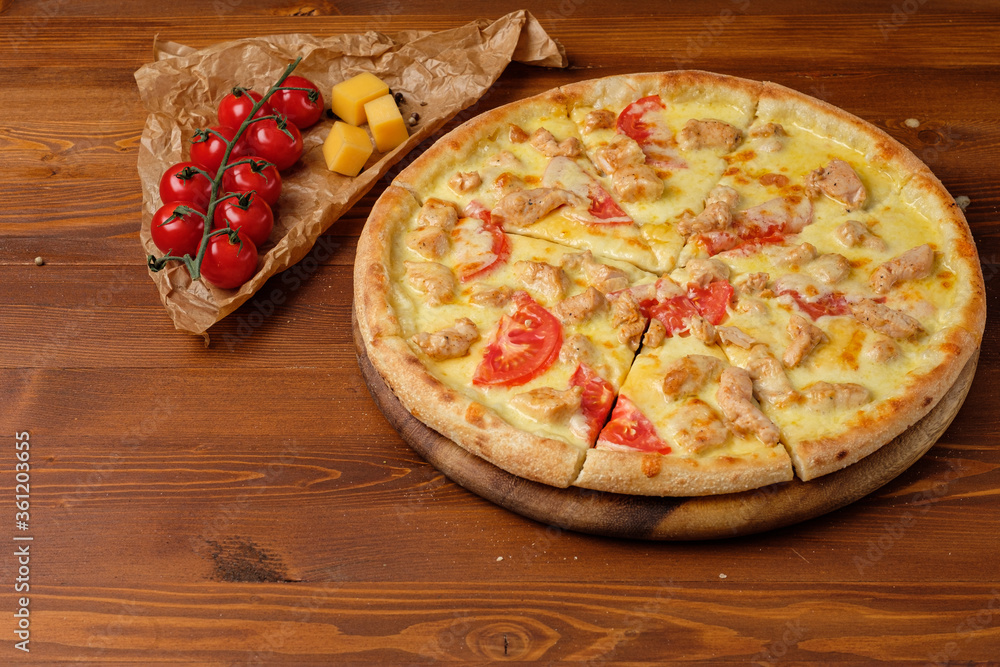 Tasty pizza with chicken and tomato