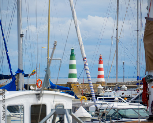 Entrance to the harbor with yachts. Red and green lighthouses at the gates of the port.