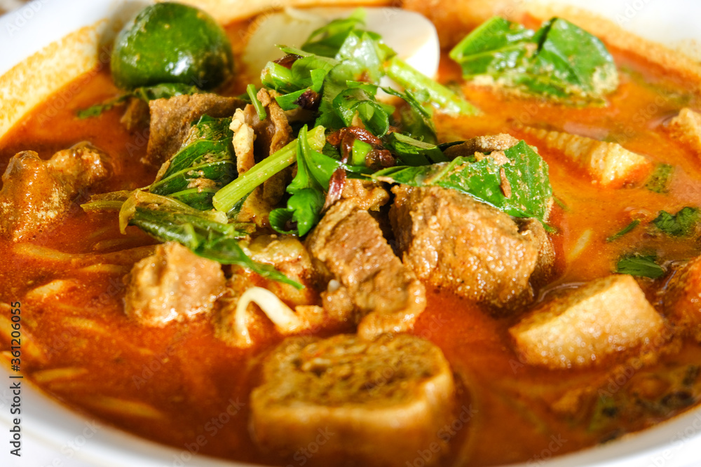 Selective focus of green leaves on mutton curry noodle during breakfast. Selective focus of green leaves on mutton curry noodle during breakfast.