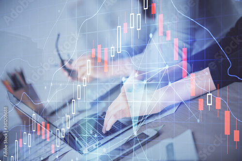 Multi exposure of woman hands typing on computer and financial chart hologram drawing. Stock market analysis concept.