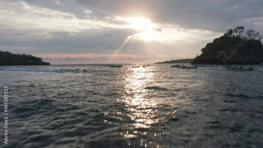 Sun Beaming from Sky and Reflecting on the Beautiful Ocean Waters in Indonesia Sun Beaming from Sky and Reflecting on the Beautiful Ocean Waters in Indonesia