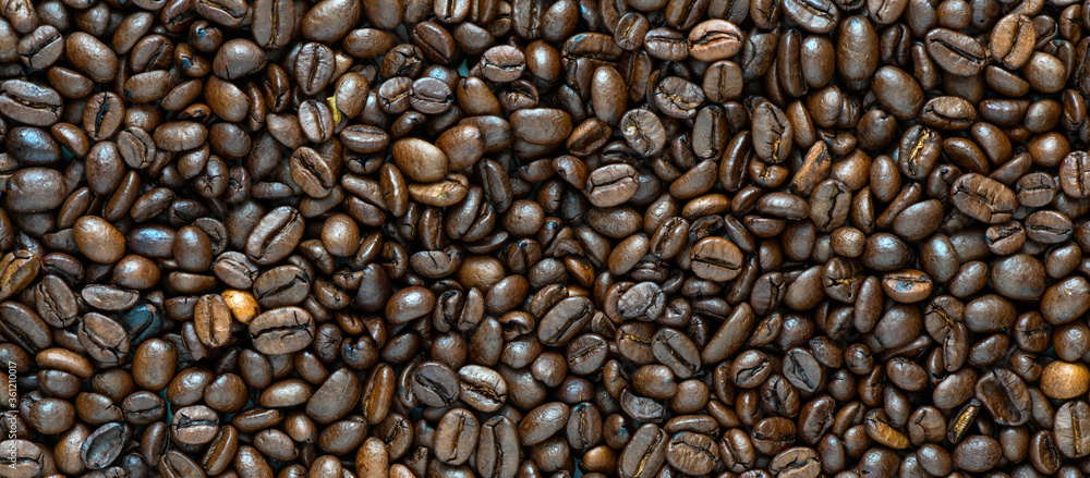 Fresh coffee beans scattered as a background or texture. Fresh coffee beans scattered as a background or texture.