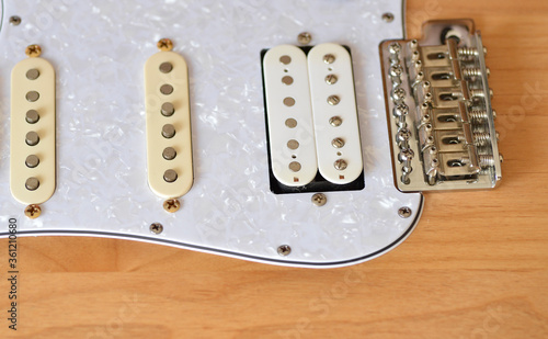 wood color electric guitar with pearl white pickguard
