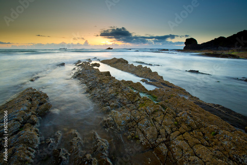 A landscape view of Broad Haven beach at dusk and sunset in Broad Haven, Pembrokeshire, Wales, UK. Taken in July 2014 photo