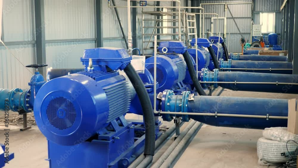 equipment at the electric pumping station. Pumps deliver water to the irrigation tank from a nearby flowing river. modern technologies in irrigation of farm fields equipment at the electric pumping station. Pumps deliver water to the irrigation tank from a nearby flowing river. modern technologies in irrigation of farm fields