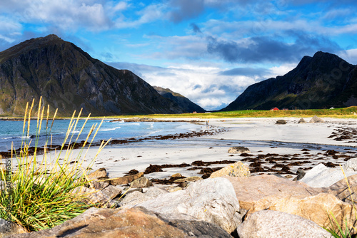 White sands washed by crystal turquoise water. Seascape views from Ramberg beach at Lofoten Islands, Norway