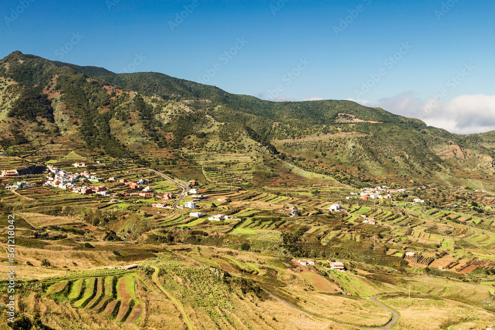 View of the valley and hills under blue sky