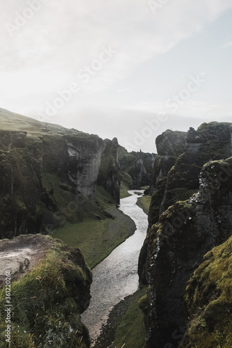 Fototapeta Naklejka Na Ścianę i Meble -  Neverland Iceland. The picturesque canyon Fjadrargljufur, green cliffs and blue water of the river