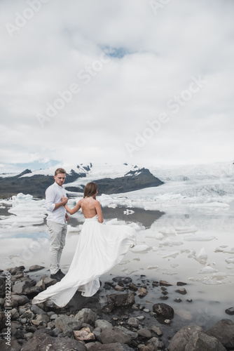 Back of just married couple taking walk on plains of Iceland