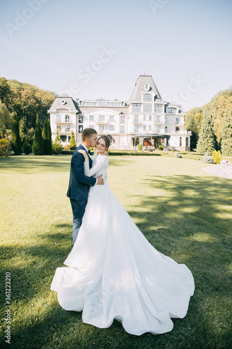 Portrait of the bride and groom with a bouquet of flowers in the park