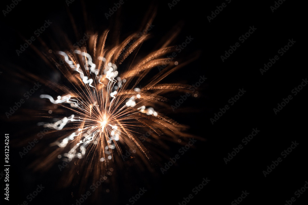 Abstract shimmering golden firework burst created using intentional camera movement
