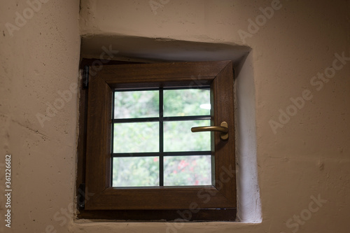 open small glass window and white wall in bathroom.