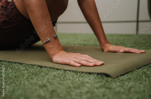 Female hands on the yoga mat