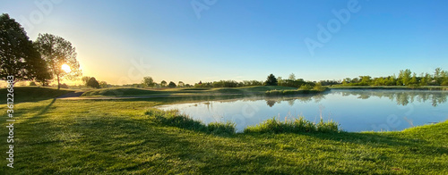 Obraz na płótnie early morning on the golf course pond geese sunny fog