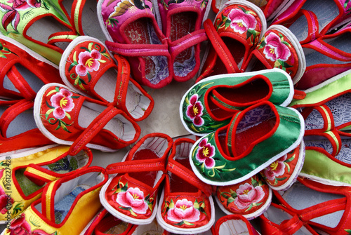 Embroidered children's shoes displayed for sale in market, Dali, Yunnan Province, China