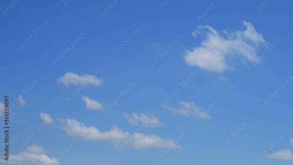 TimeLapse of Sunny clear blue sky background with beautiful minimal white cumulus clouds & fluffy cloudscape rolling on bright daylight horizon in tropical summer sunlight & sun rays, B-roll footage TimeLapse of Sunny clear blue sky background with beautiful minimal white cumulus clouds & fluffy cloudscape rolling on bright daylight horizon in tropical summer sunlight & sun rays, B-roll footage