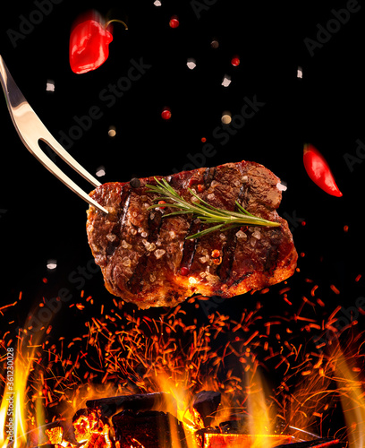 Beef steak falling on the grill with fire. Brazilian barbecue