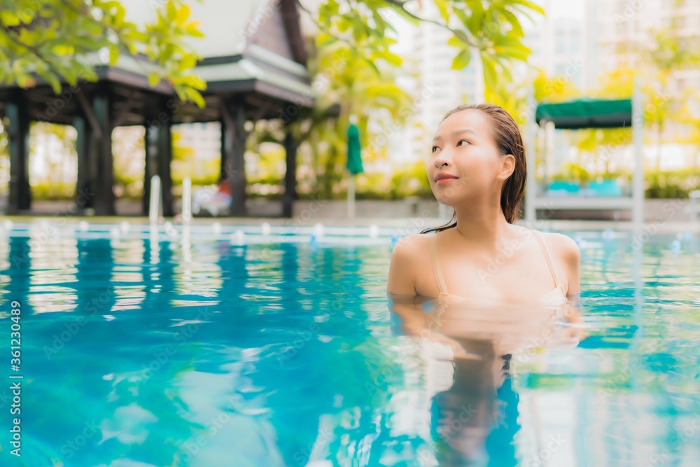 Portrait beautiful young asian woman relax happy smile leisure around outdoor swimming pool