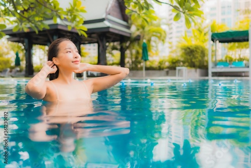 Portrait beautiful young asian woman relax happy smile leisure around outdoor swimming pool