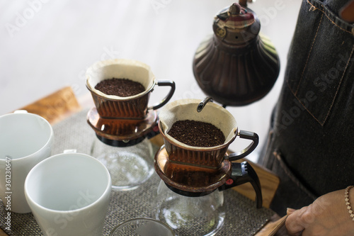 Alternative manual hand coffee brewing in origami dripper with paper filter.