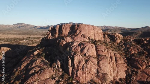 4K aerial drone video of African savanna hills, large red granite boulders range near B1 highway south of Windhoek in central highland Khomas Hochland of Namibia, southern Africa