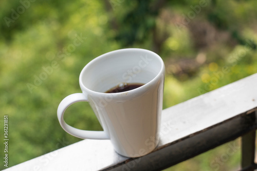 Coffee cup on wooden table in coffee shop.