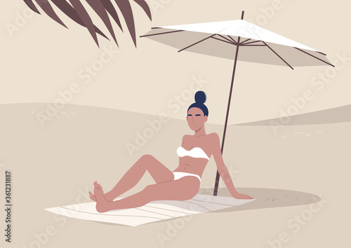 Young woman sitting on the beach under umbrella, summertime vacation, hot tropical climate