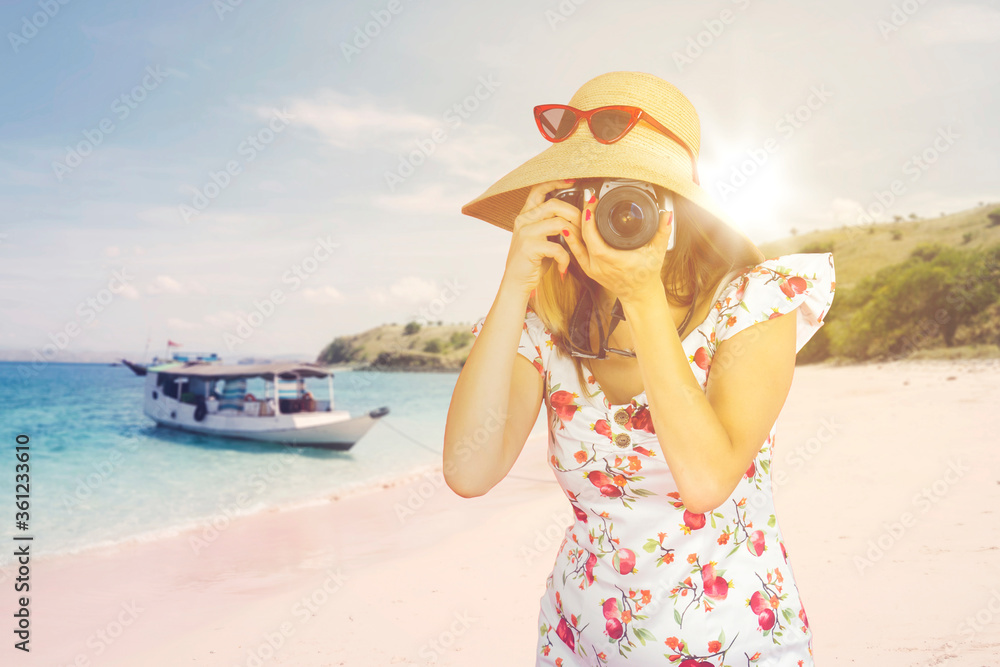 Tourist taking picture with dslr camera on beach