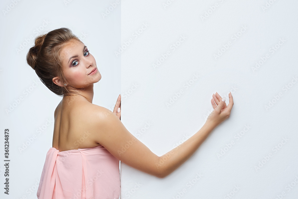beautiful girl posing in front of the camera. he points to an empty space. advertising concept beautiful girl posing in front of the camera. he points to an empty space. advertising concept