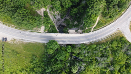Aerial Image of a Road through a forest surrounded by trees