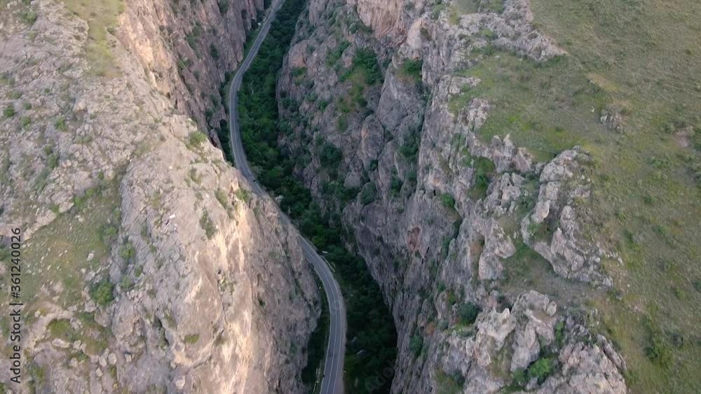Road passing through canyon drone reveal shot Road passing through canyon drone reveal shot