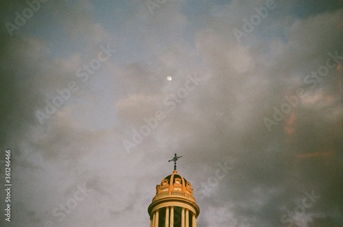 Church in clouds below the moon in Madrid, Spain 