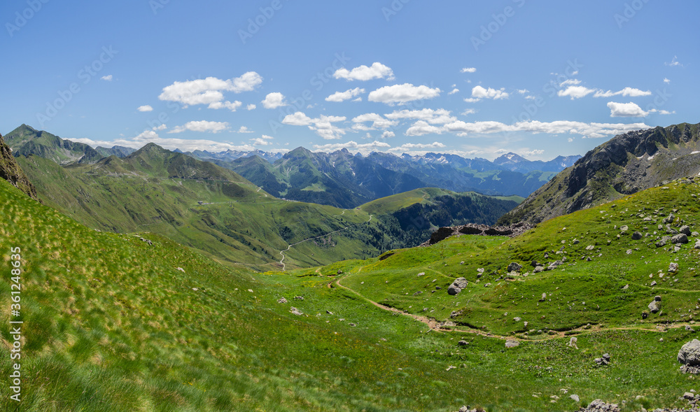 San Marco mountain pass, Italy. Amazing landscape of the Alps on a sunny day. Contrast between the green of the meadows and the blue of the sky. Italian alps. North Italy