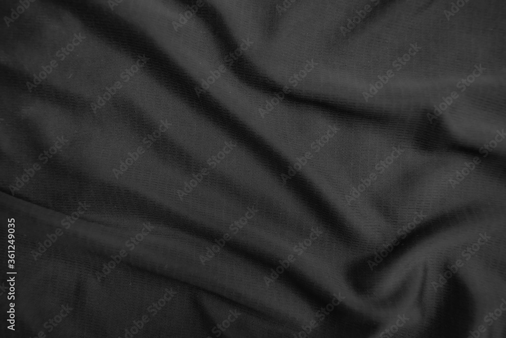 Background texture black cloth. Abstract dark wavy soft. Fabric is wrinkled. Fashion luxury style.