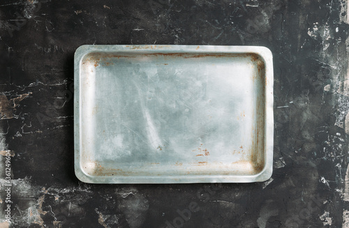 Clean baking sheet on the rustic background. Selective focus. Shot from above.